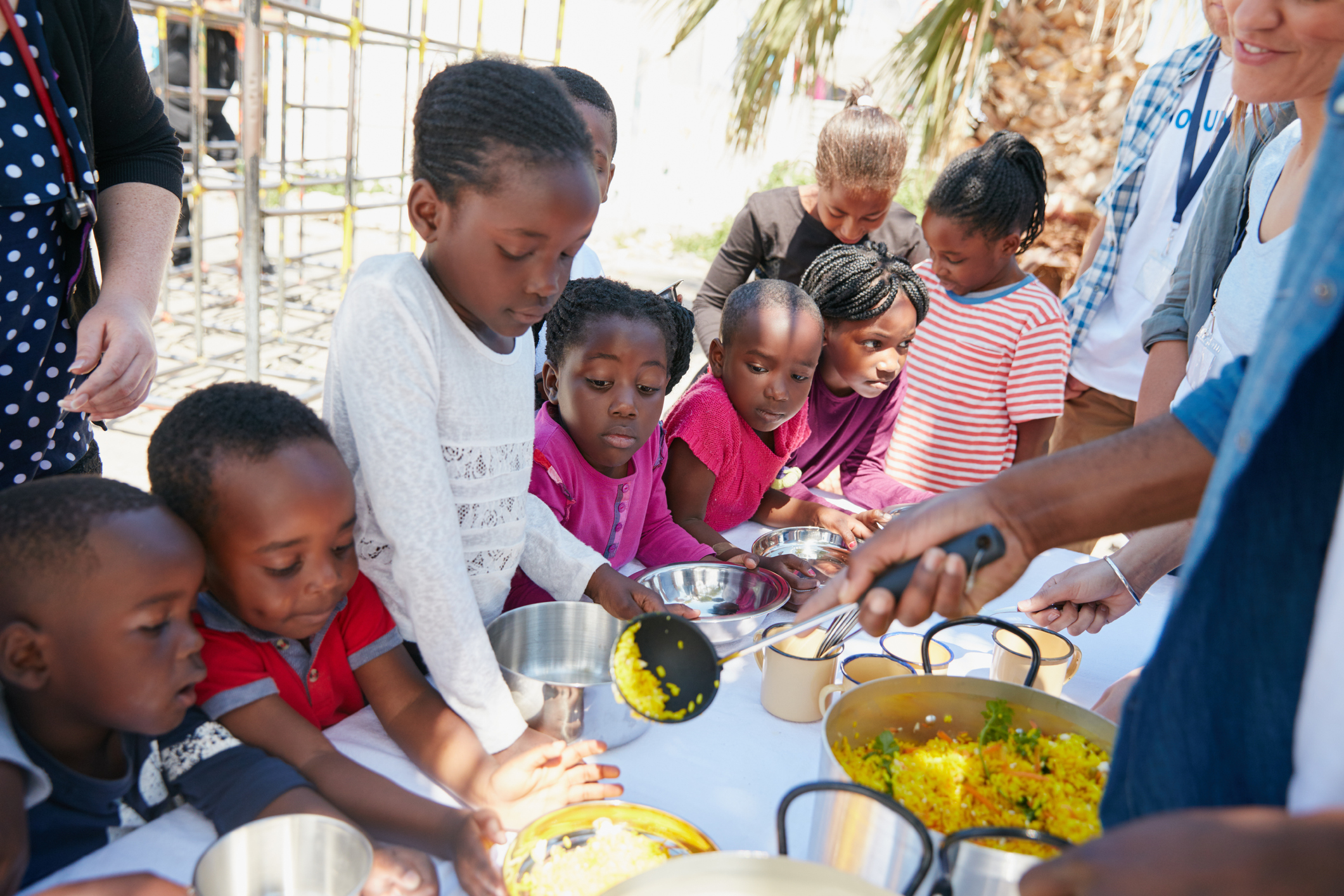 Cropped shot of children getting fed at a food outreach